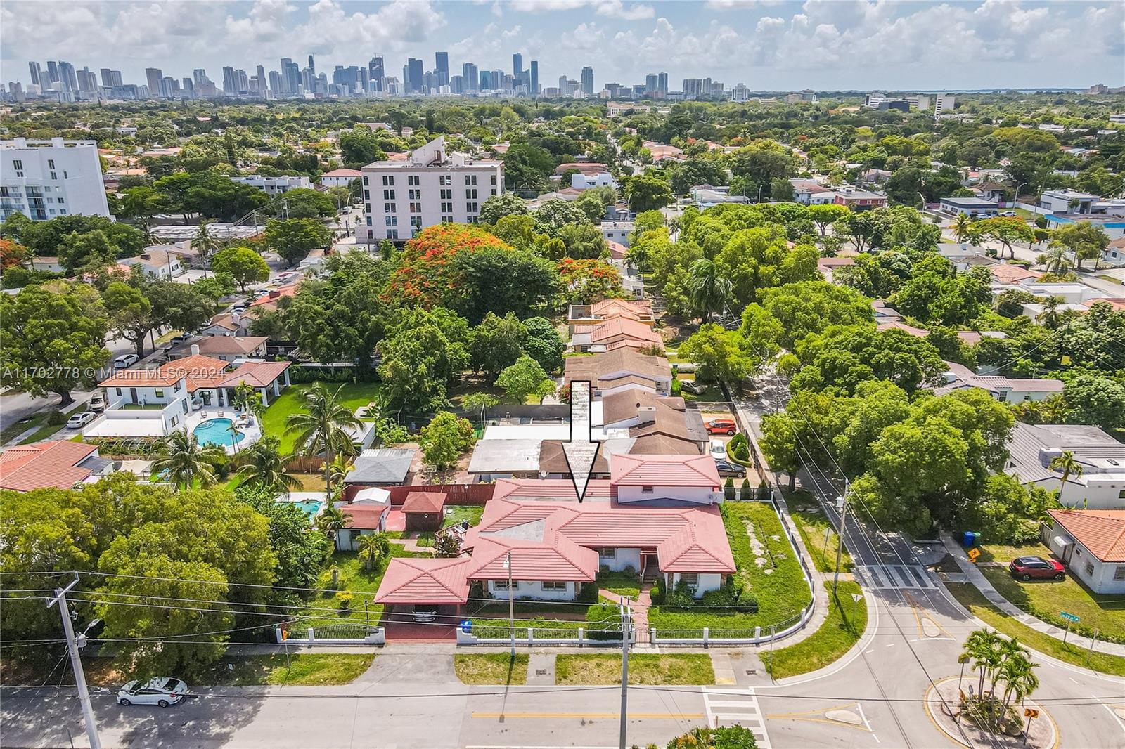 an aerial view of residential houses with outdoor space and swimming pool