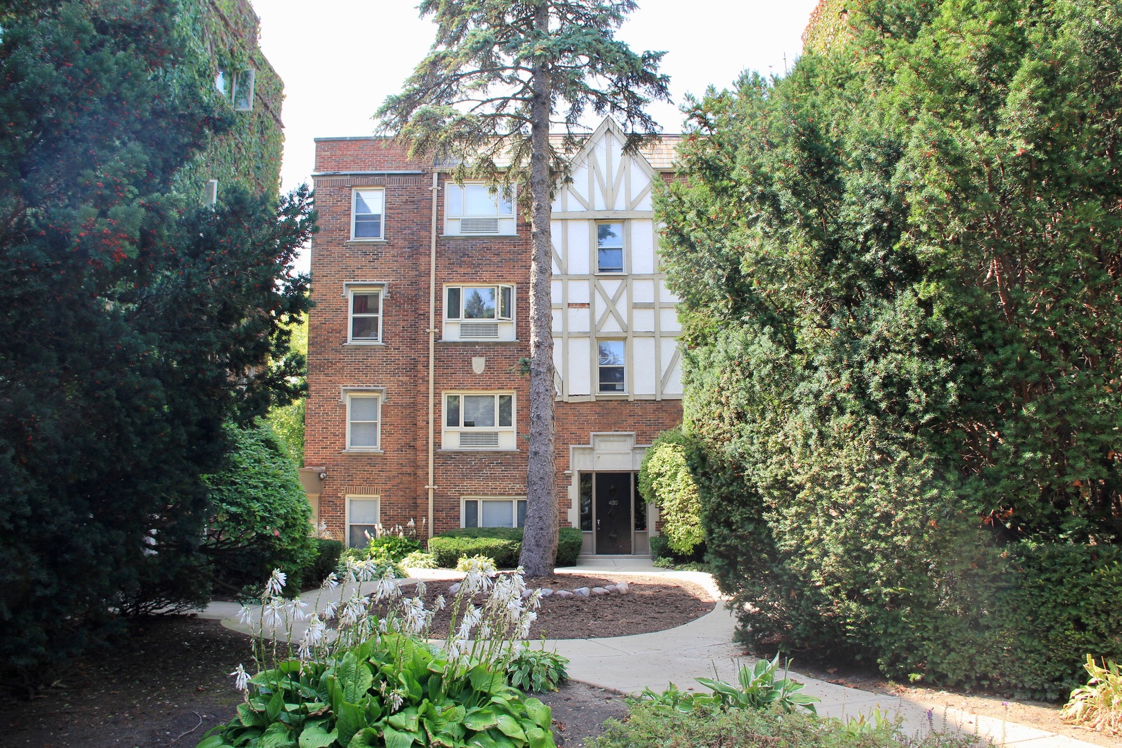 a view of a brick building next to a yard