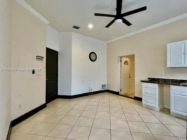 a view of an empty room with window and cabinet