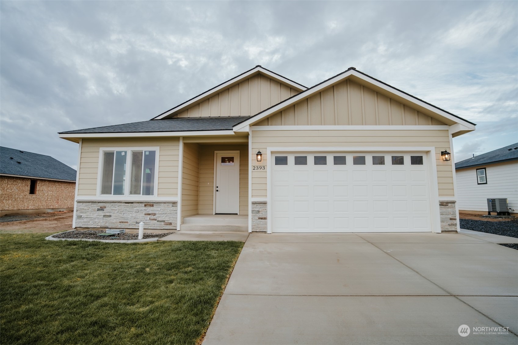 a view of a house with a yard and garage