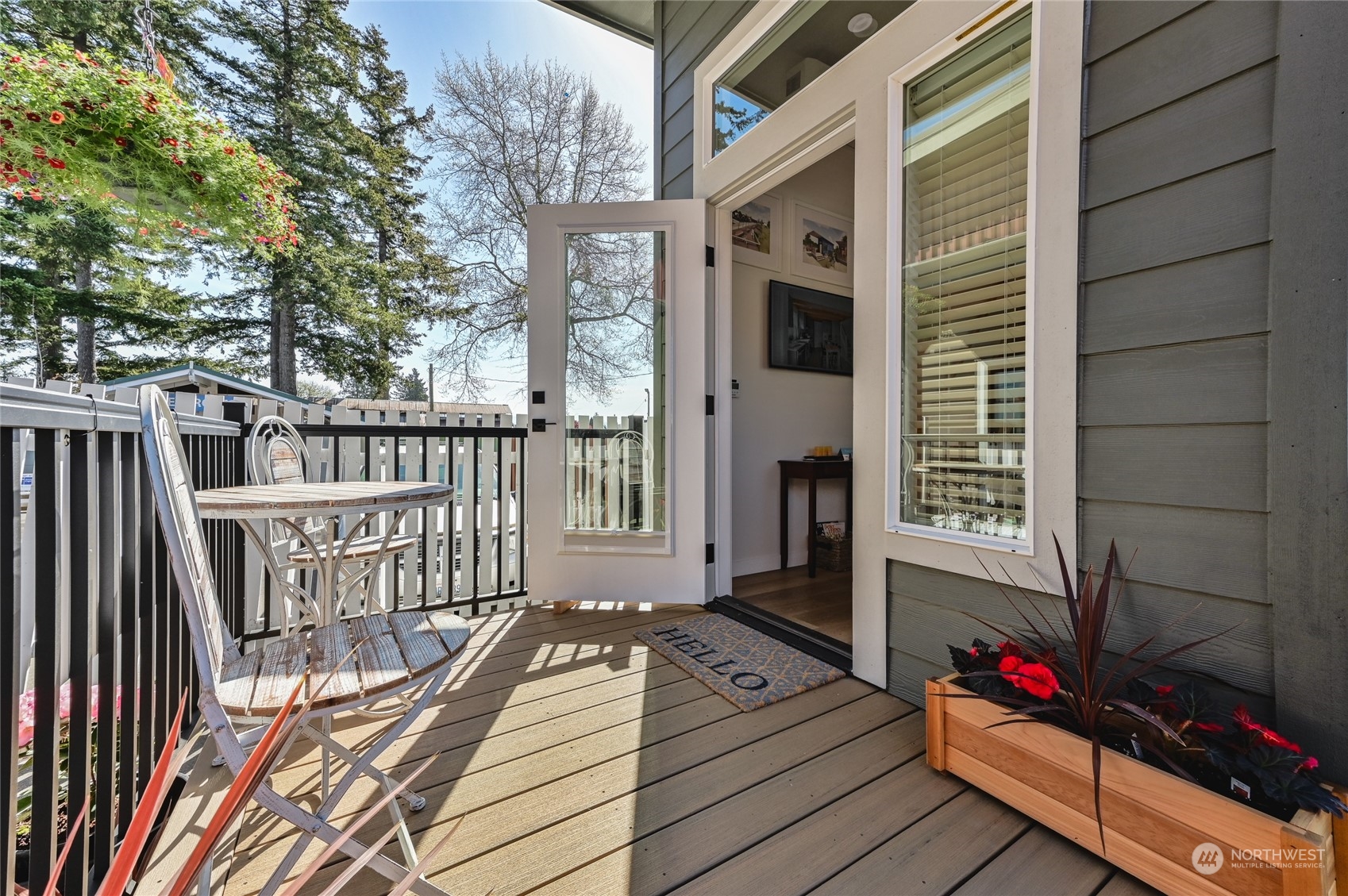 a view of a balcony with wooden floor and fence