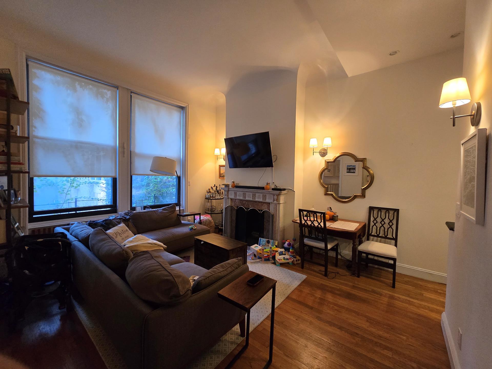 a living room with furniture a fireplace and a flat screen tv