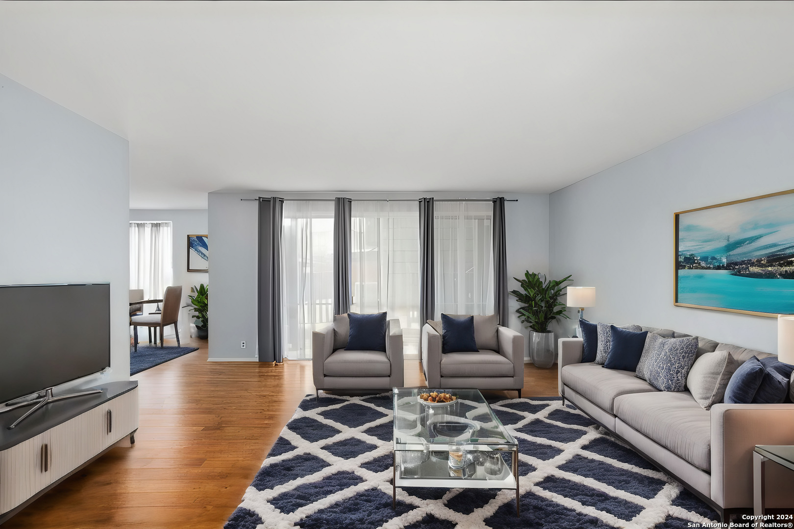 a living room with furniture and wooden floor