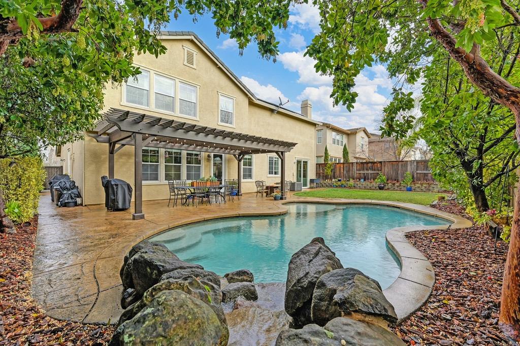 a view of a house with swimming pool and sitting area