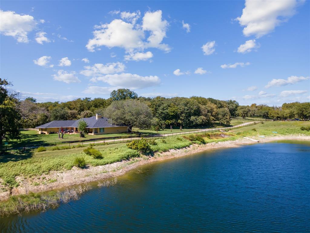 a view of a lake with a house in the background