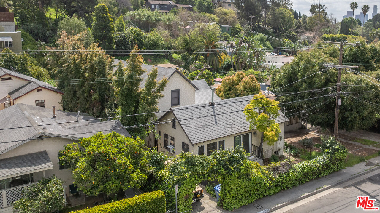 an aerial view of a house with a yard basket ball court and outdoor seating