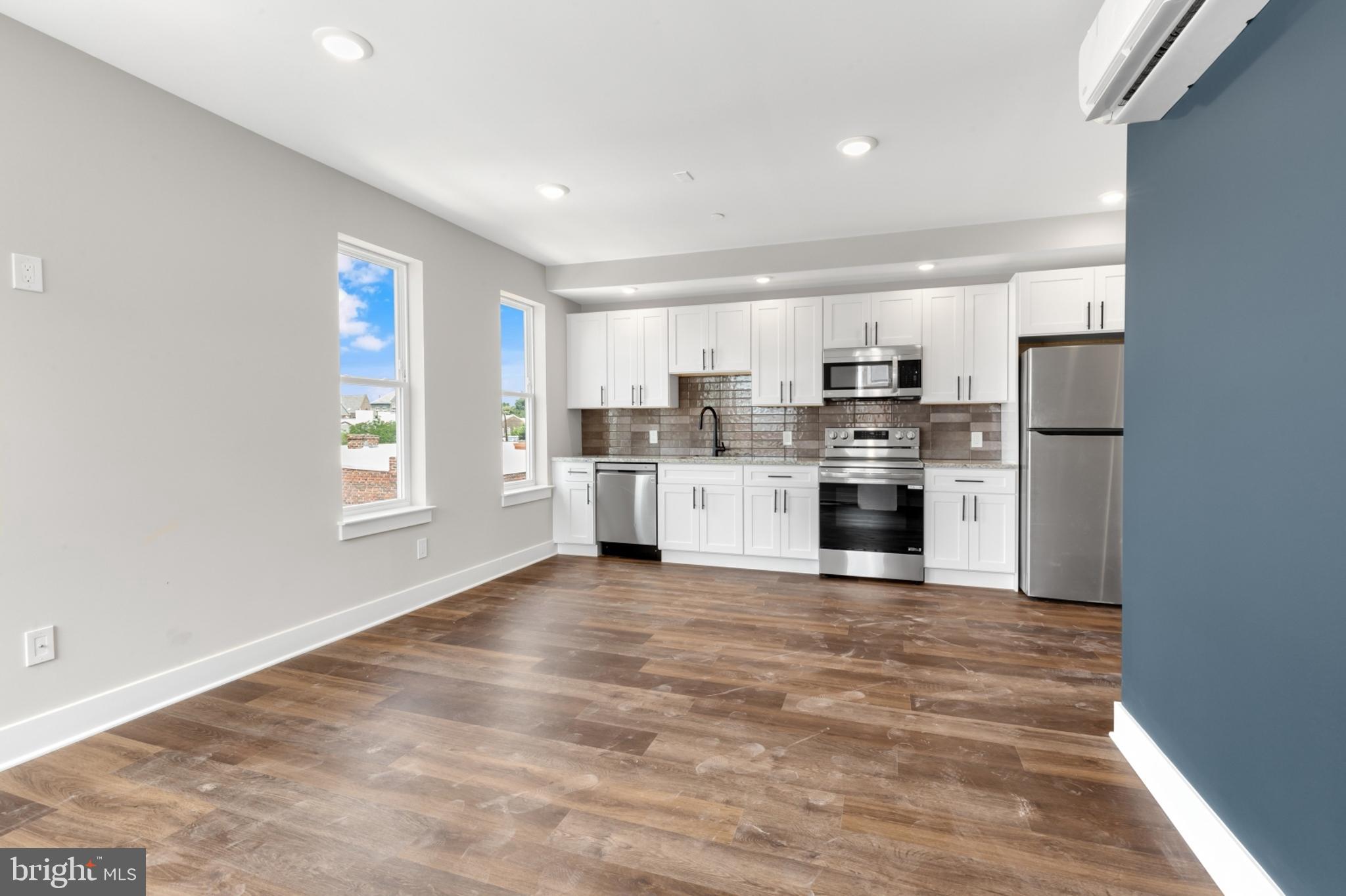 a kitchen with stainless steel appliances granite countertop a stove and a refrigerator