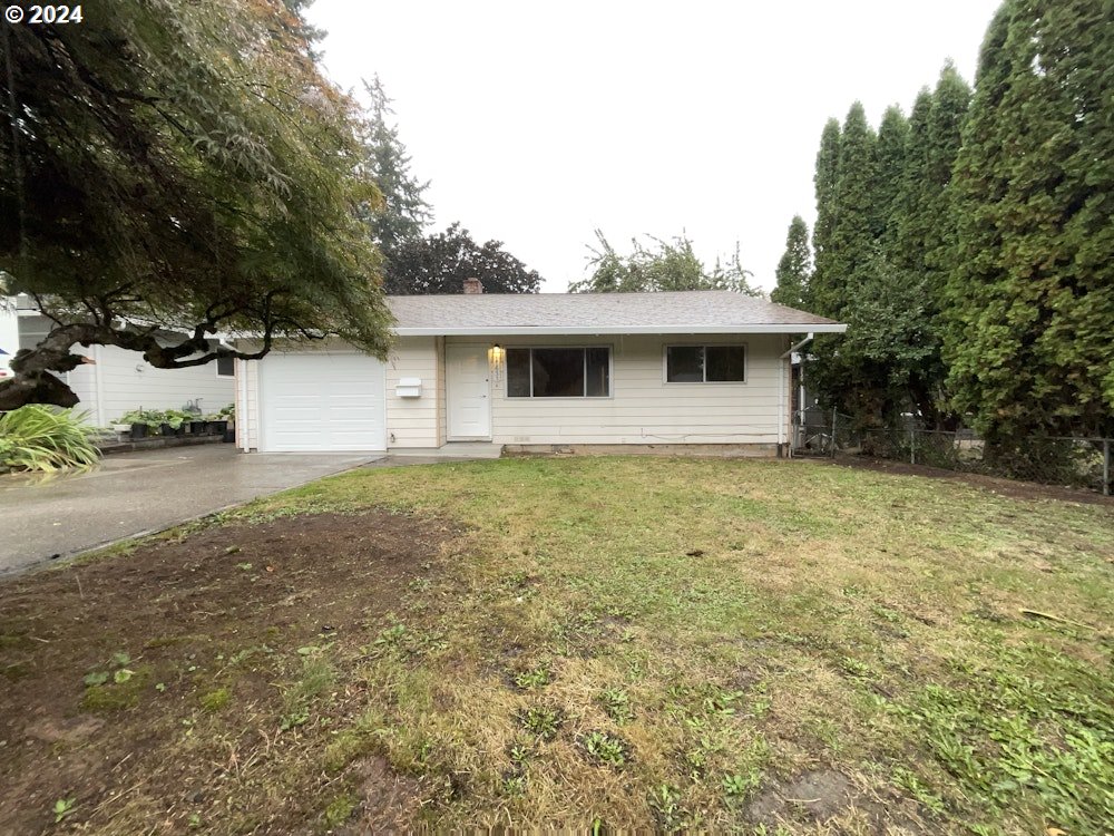 a front view of house with yard and trees