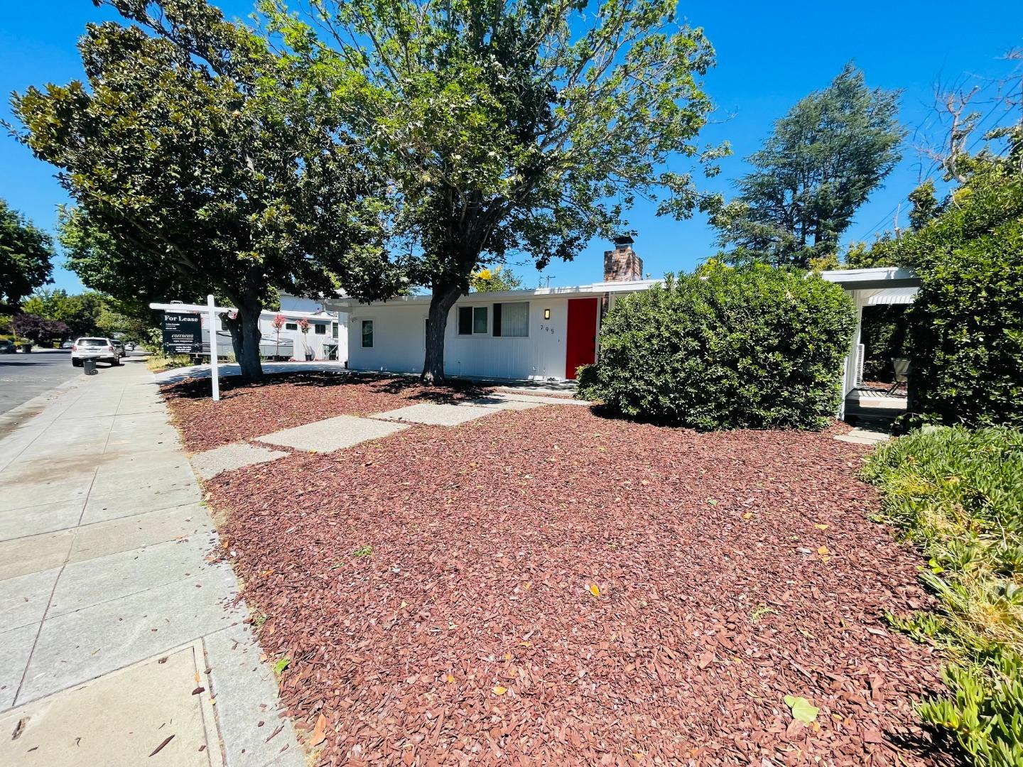 a pathway of a house with a yard