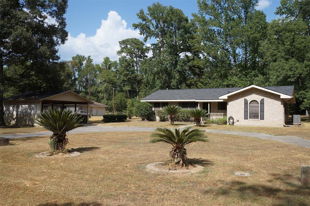 a view of a house with a yard and sitting area