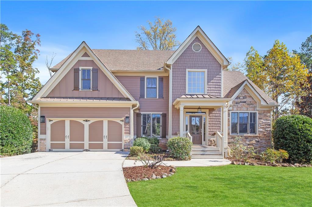 a front view of a house with a yard and garage