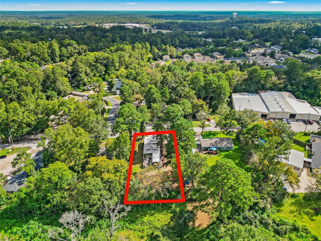 an aerial view of a houses with a yard