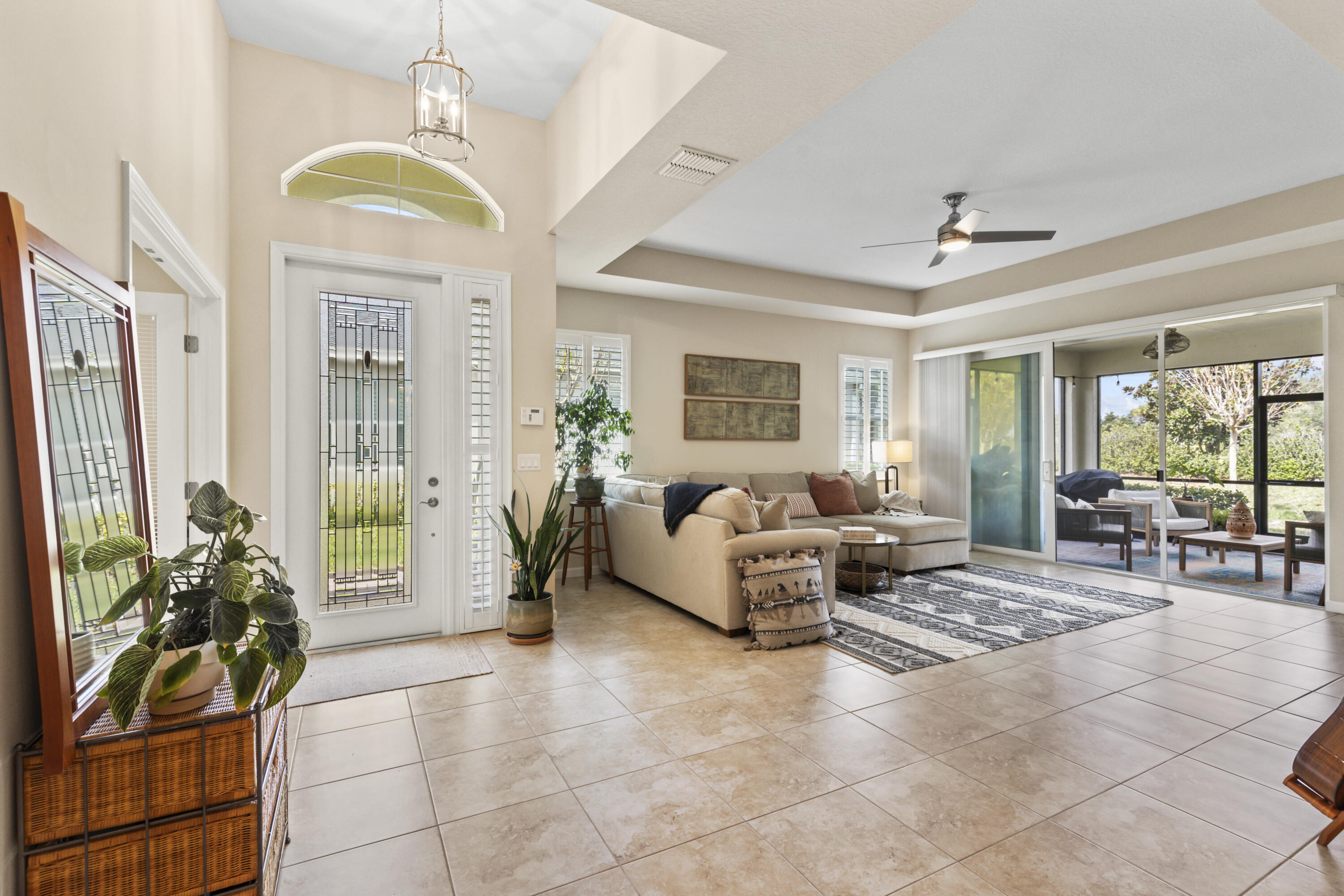 a living room with furniture and a chandelier