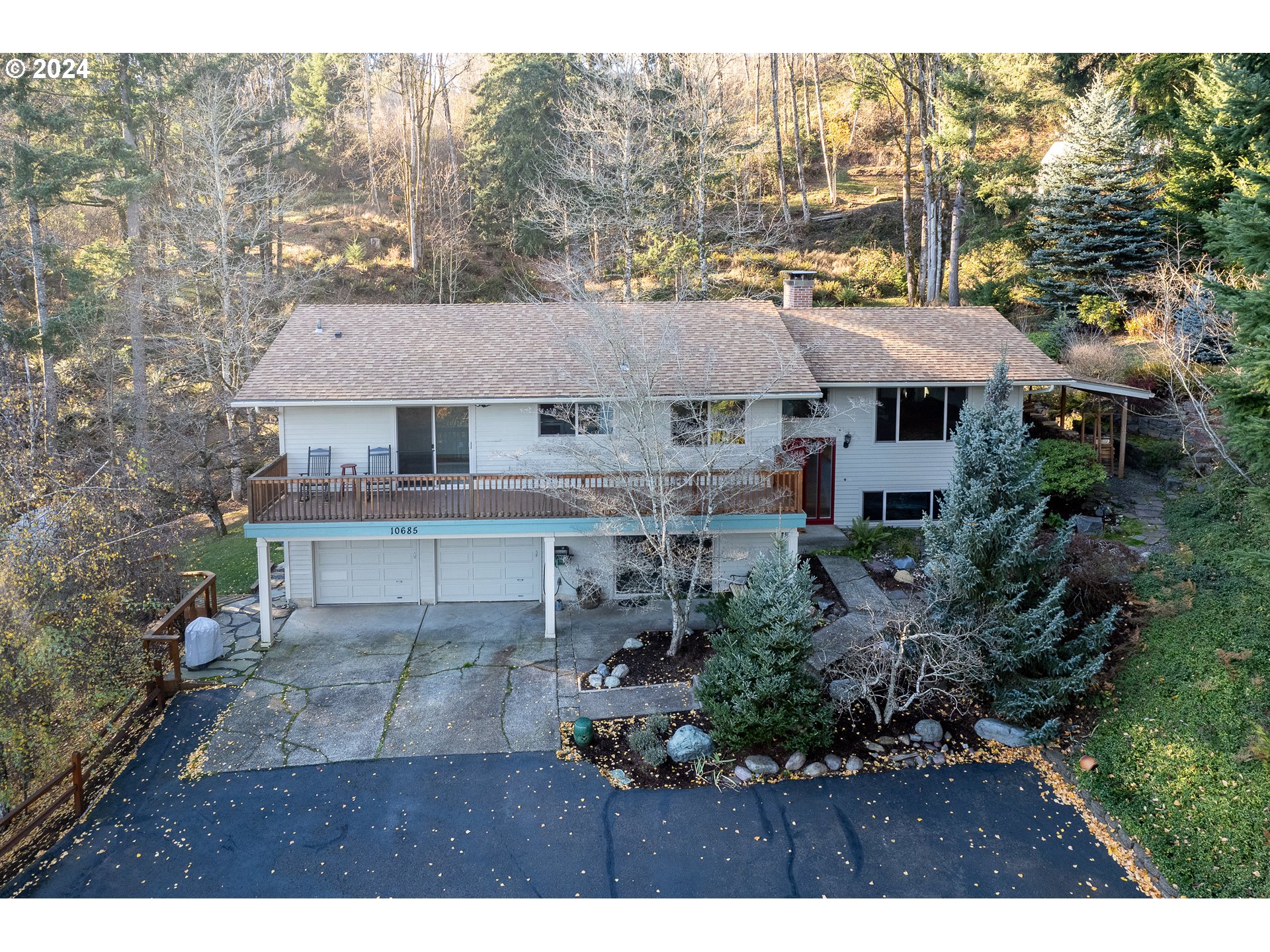 a aerial view of a house with a yard and sitting area