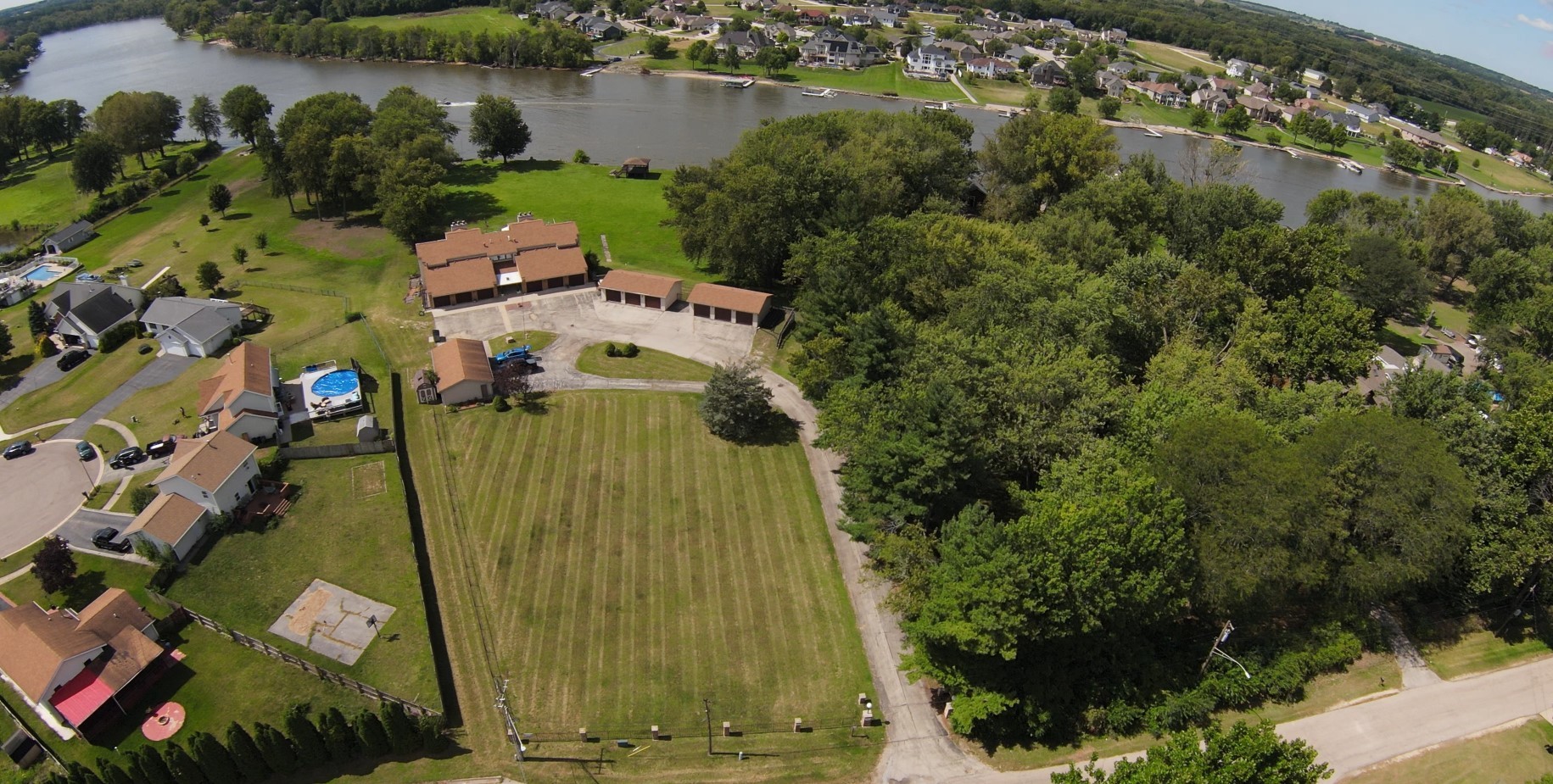 an aerial view of residential house with outdoor space and lake view