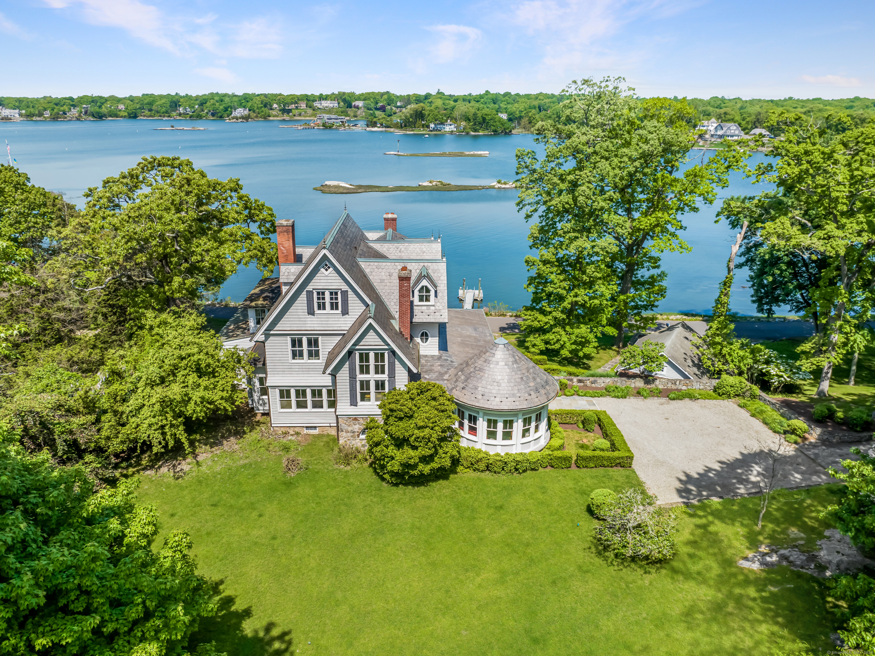 an aerial view of a house with outdoor space and a lake view in back