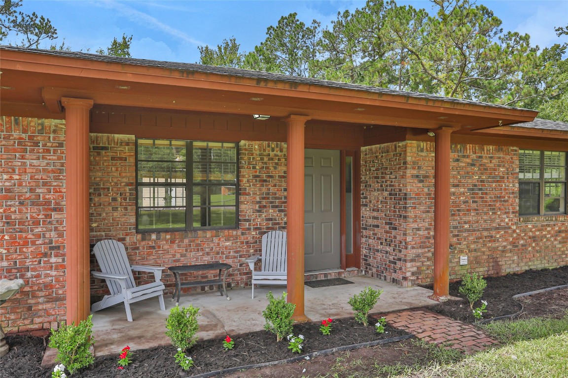 a view of a patio with table and chairs and potted plants