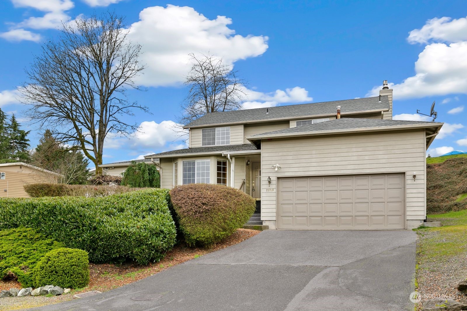 a front view of a house with a garage