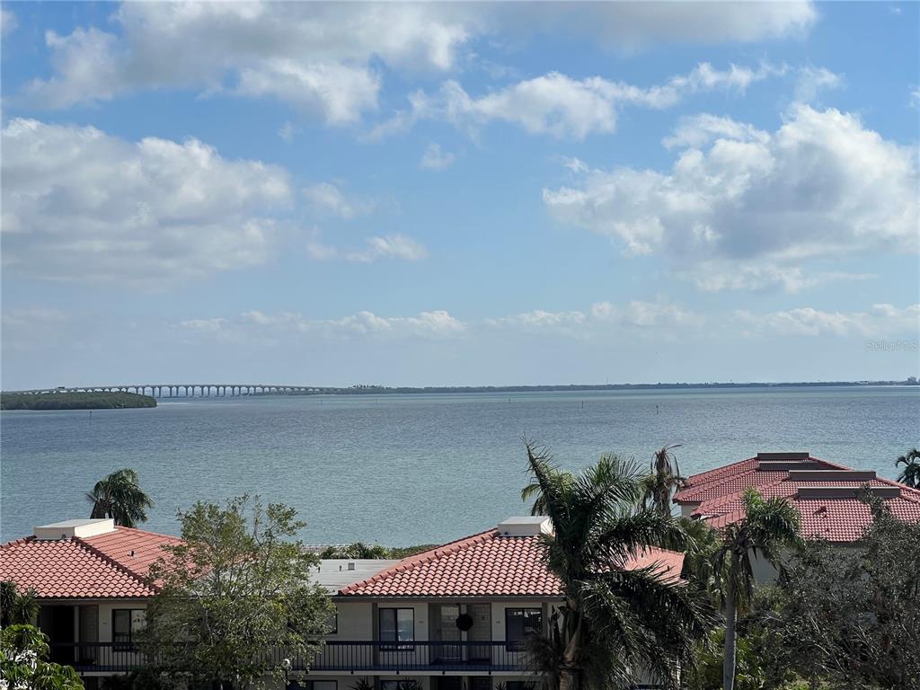 a front view of a house with a yard and lake view