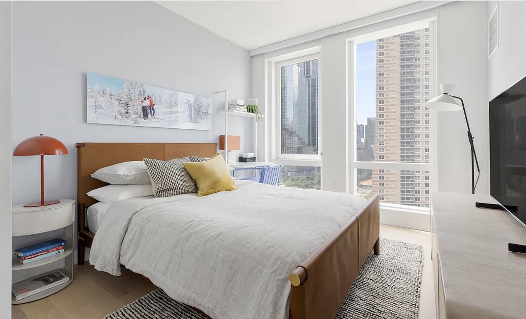 a bedroom with bed and a flat screen tv