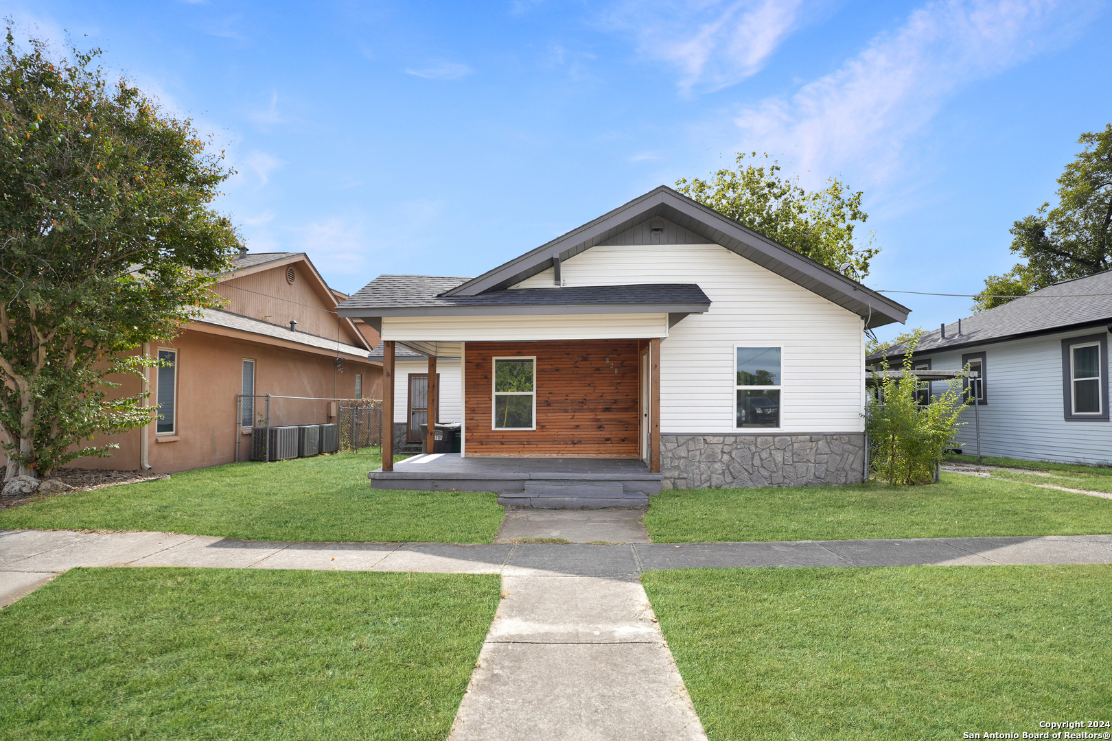 a front view of house with yard and green space