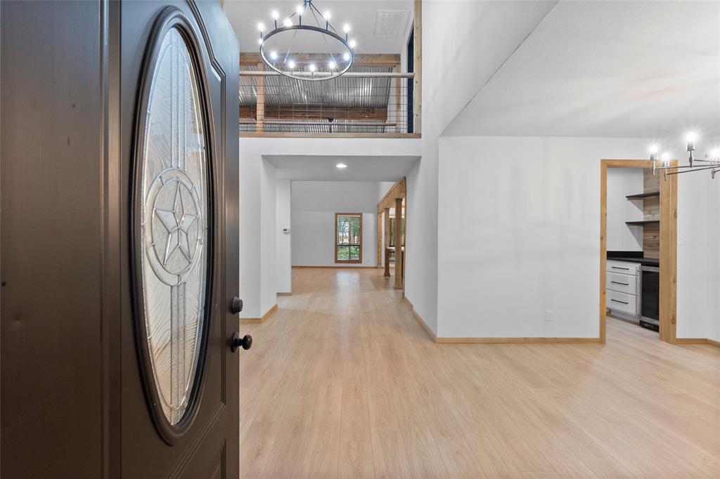 a view of livingroom with hallway and chandelier