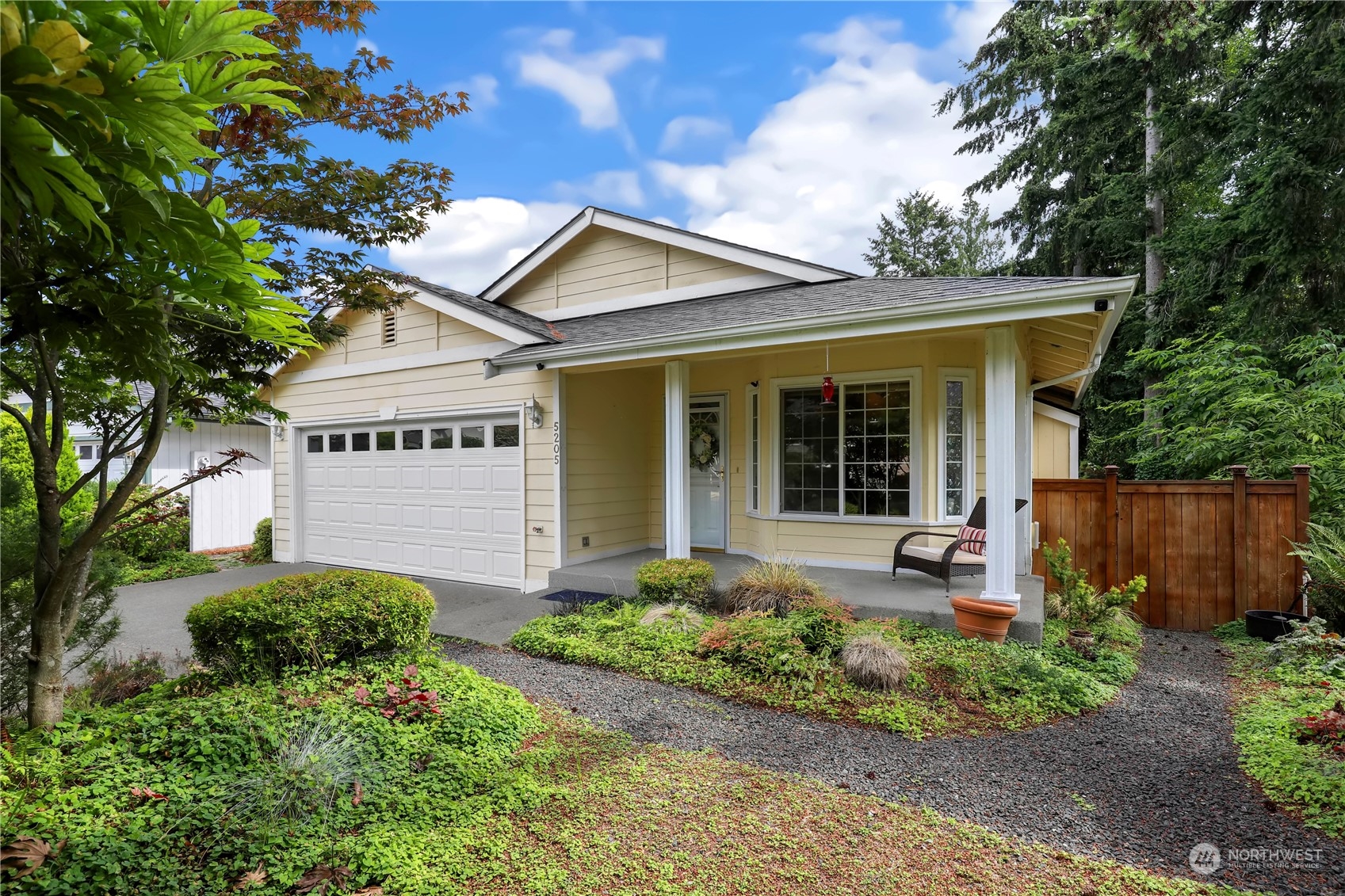 a front view of a house with garden and porch