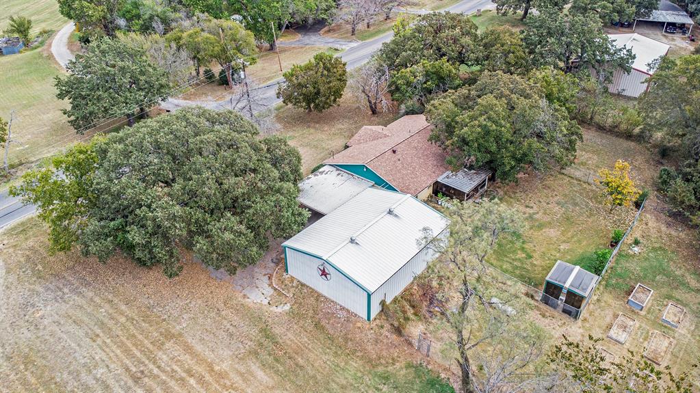 an aerial view of a house with a yard and trees