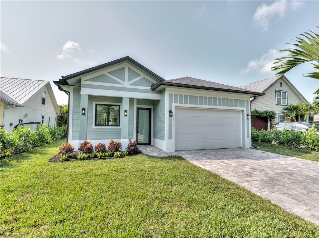 View of front of house featuring a front yard and a garage