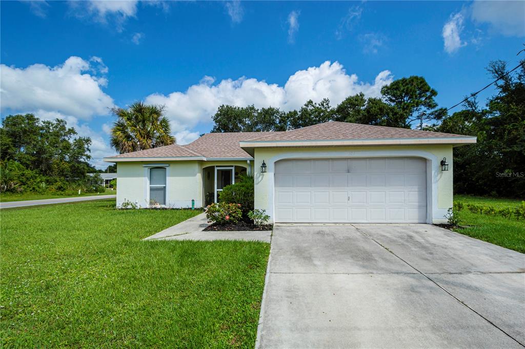 a front view of a house with a yard and garage