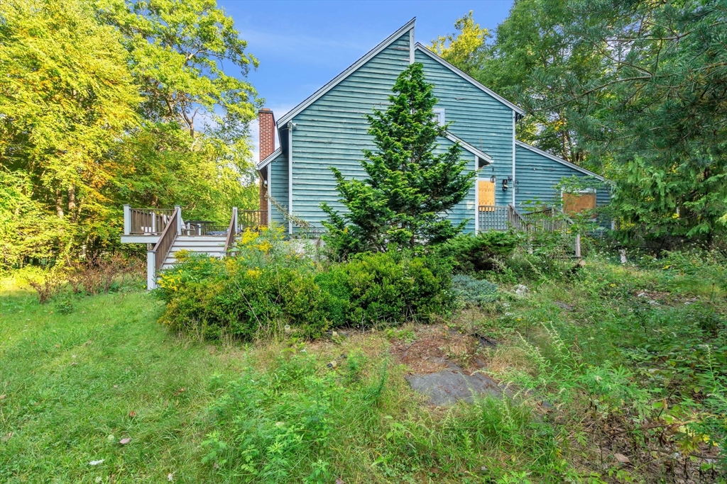 a front view of house with yard and trees