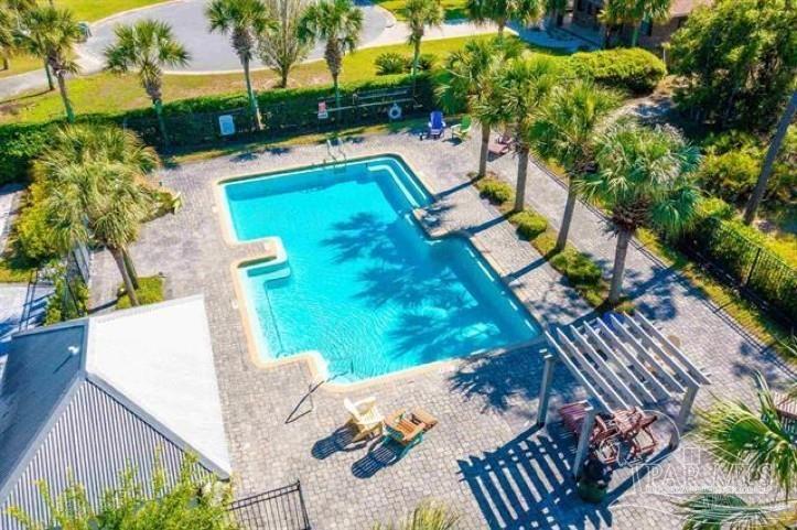 a view of a swimming pool with a patio and plants