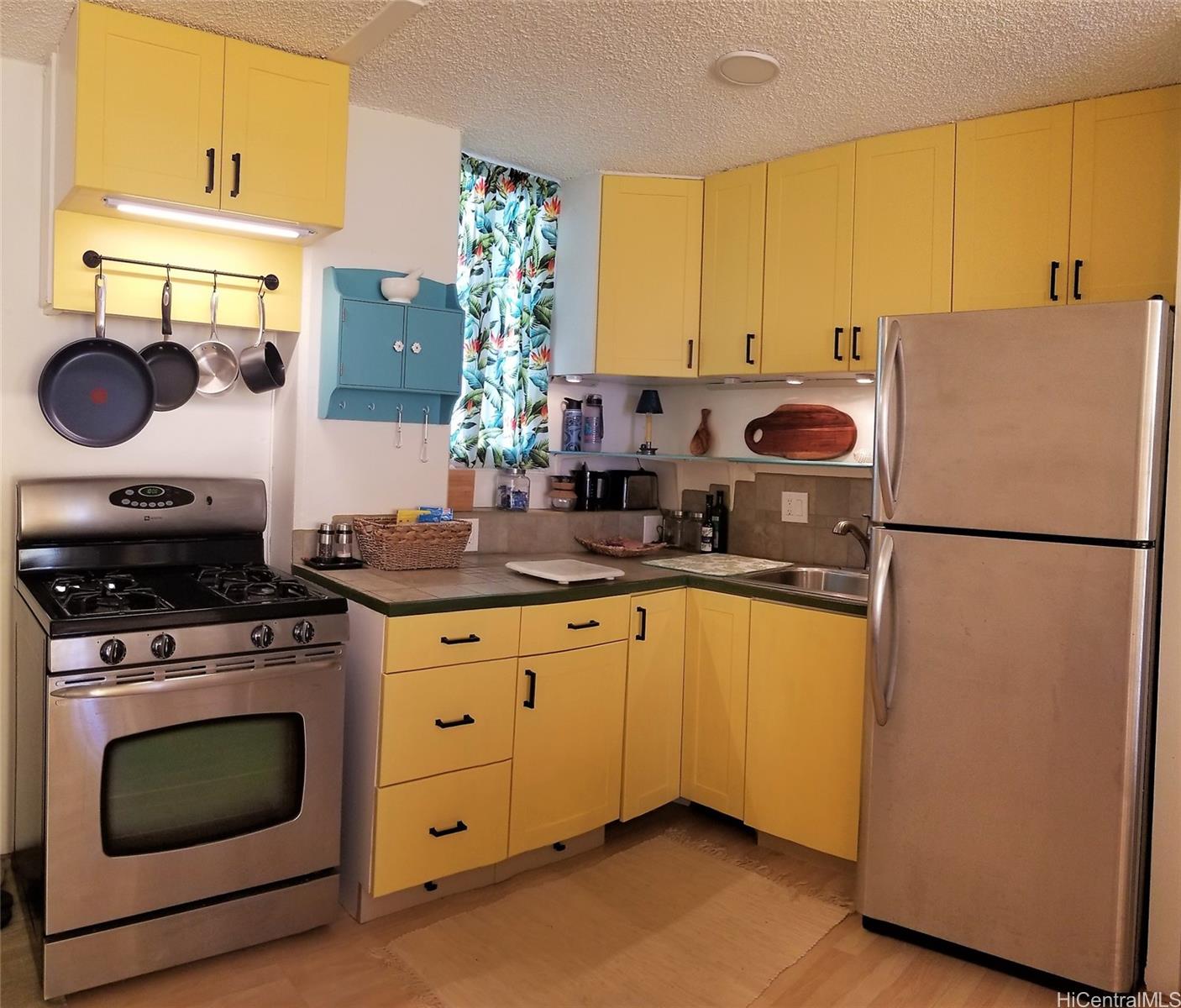 a kitchen with a stove a sink and a refrigerator