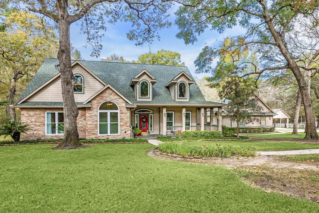 a front view of a house with a garden and trees