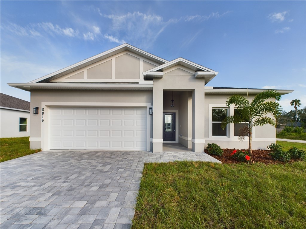 a front view of a house with a yard and garage