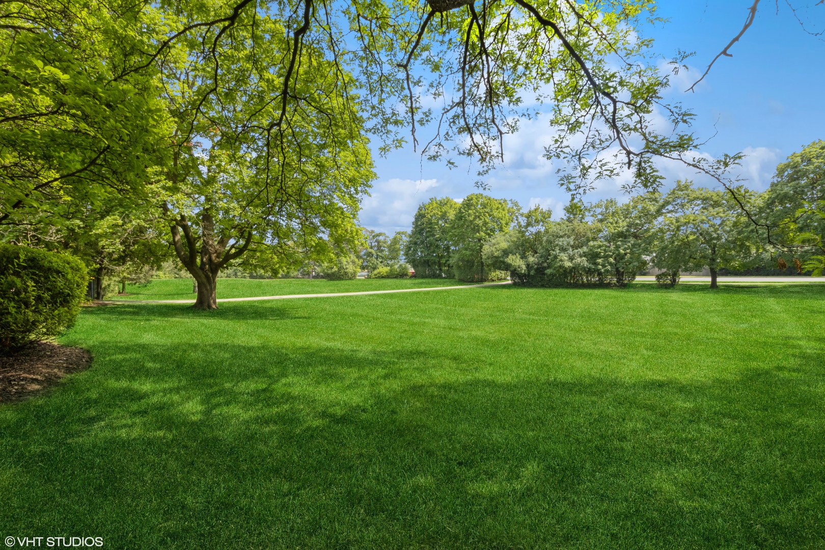 a view of grassy field with benches