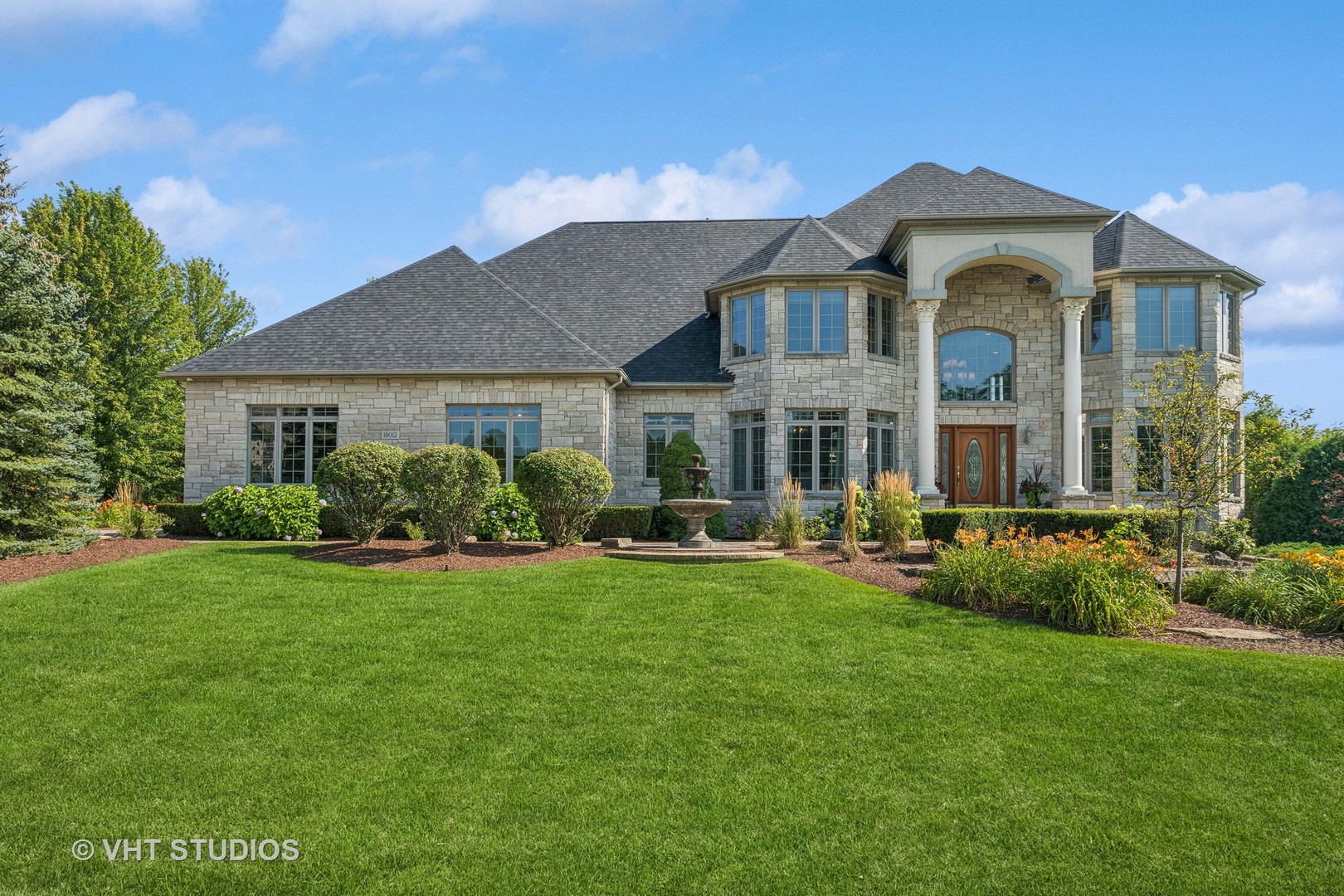 a front view of a house with swimming pool having outdoor seating