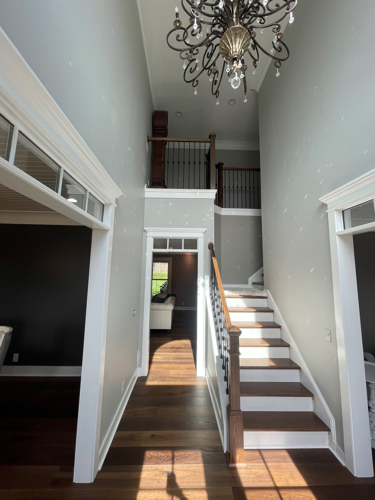 a view of entryway and hall with wooden floor