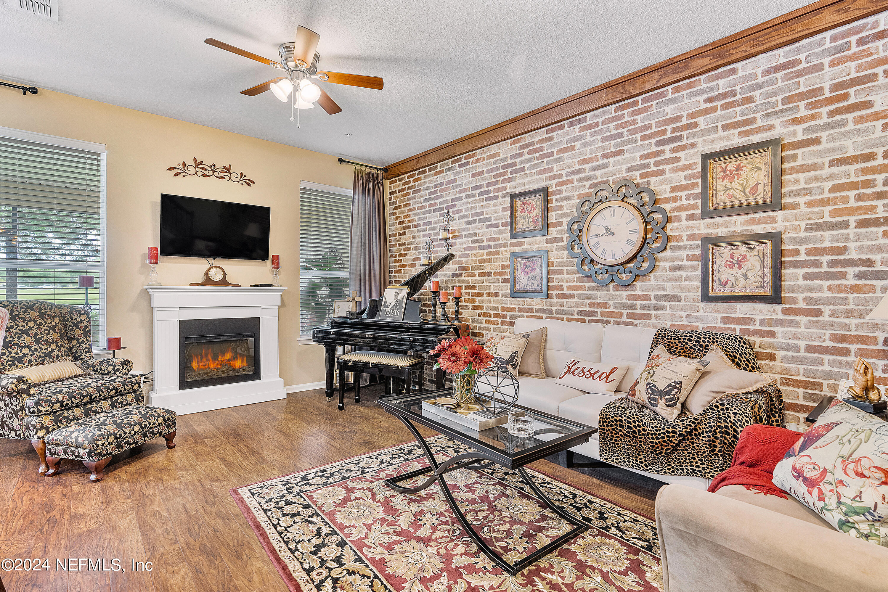 a living room with furniture a flat screen tv and a fireplace