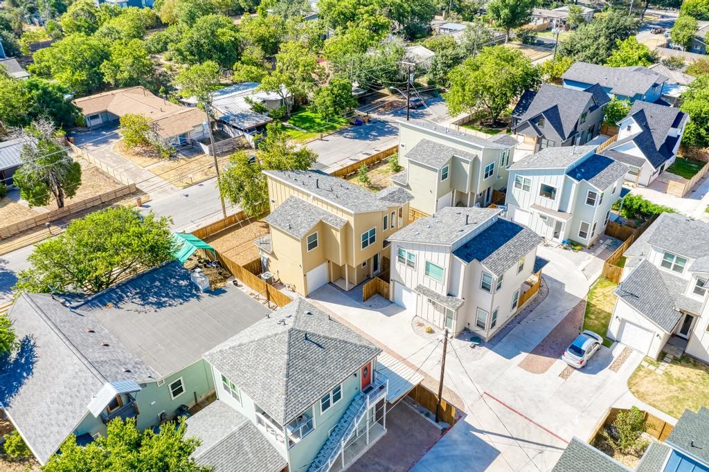 an aerial view of residential houses with outdoor space