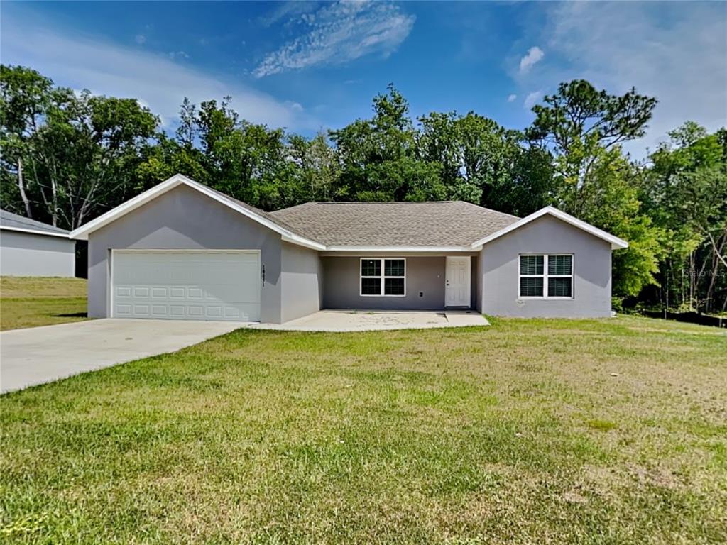 a house with green field in front of it