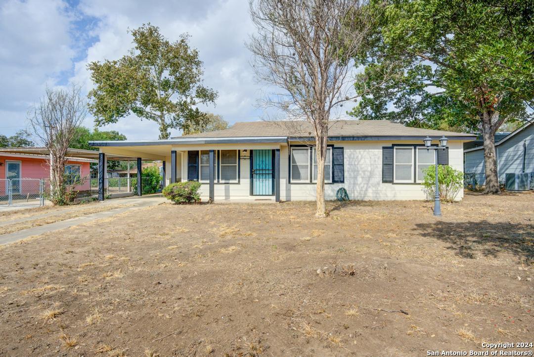 front view of a house with a tree