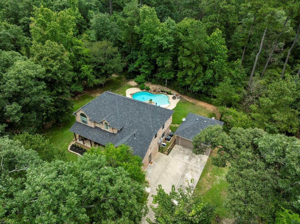 an aerial view of a house with yard swimming pool and outdoor seating