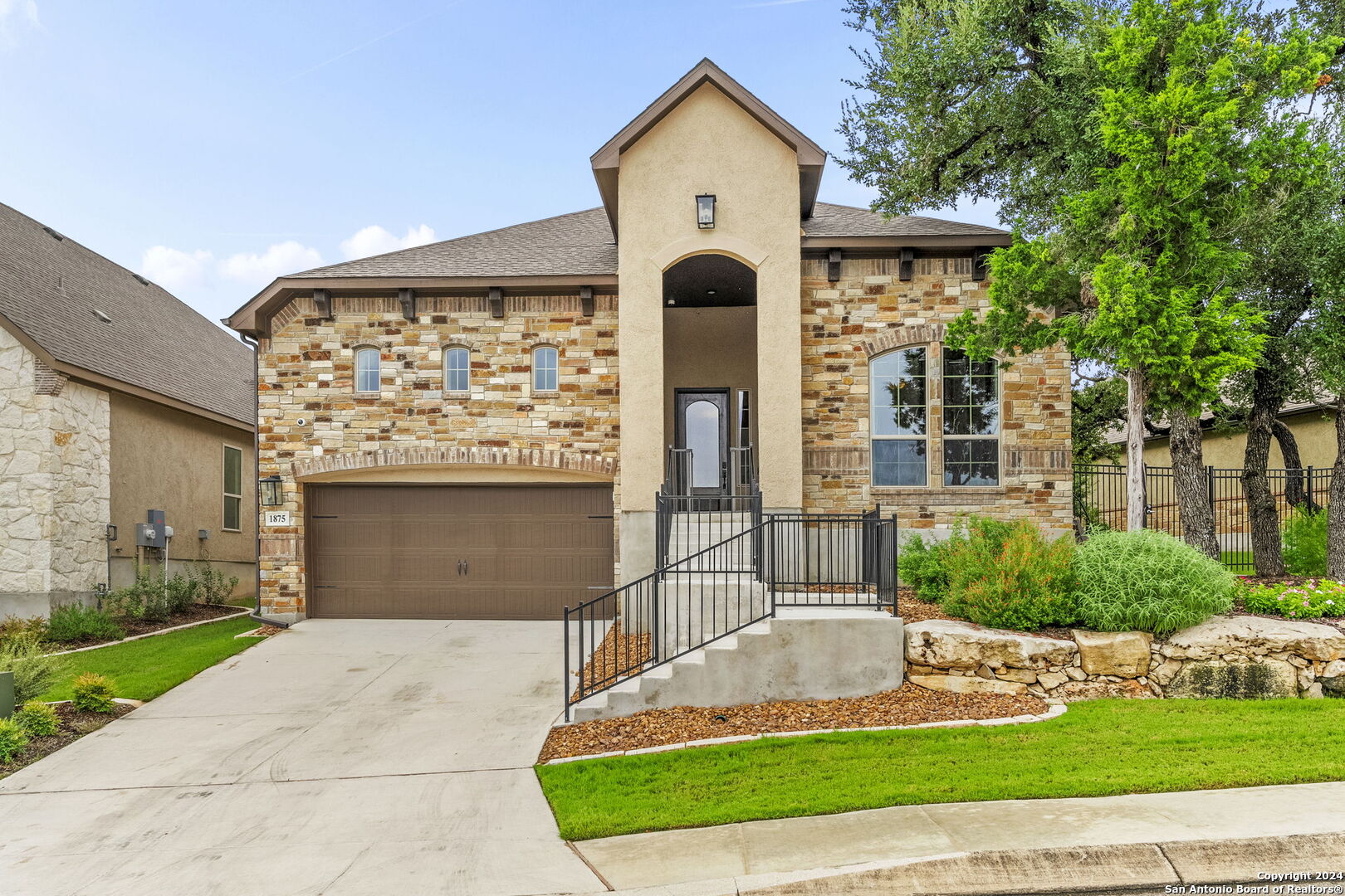 a front view of a house with a yard and garage