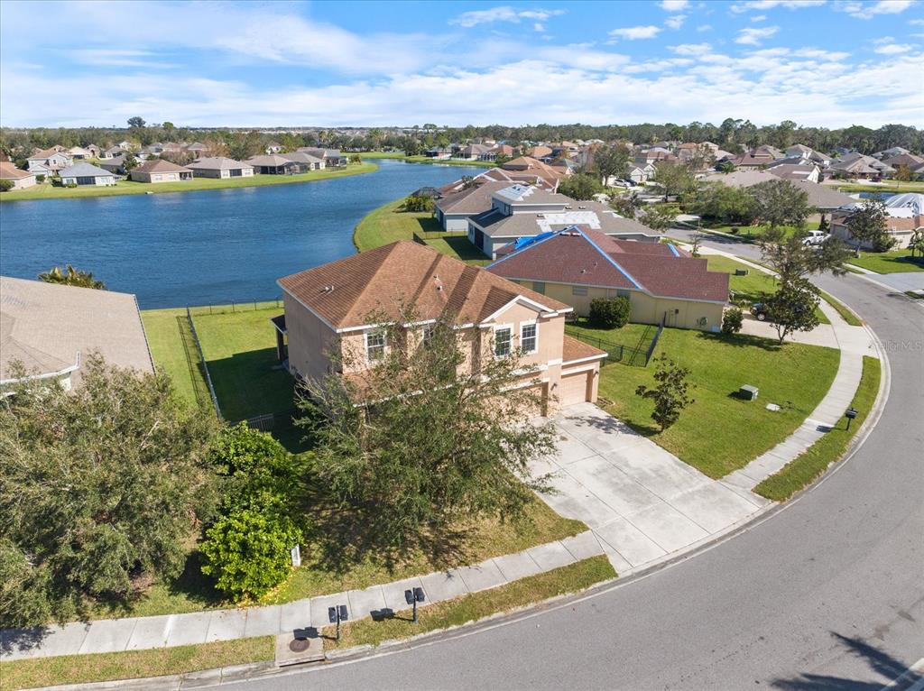 an aerial view of residential houses with outdoor space and river