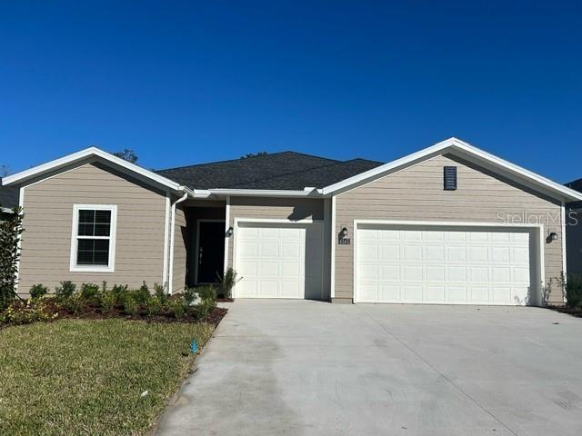 a front view of house with garage and yard