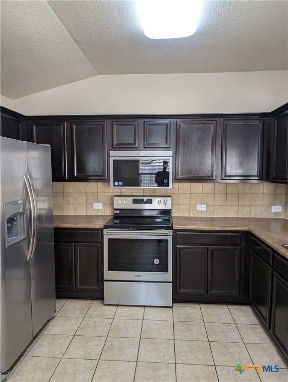 a kitchen with granite countertop a stove and cabinets