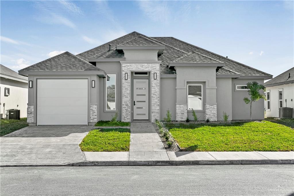 a front view of a house with a yard and garage