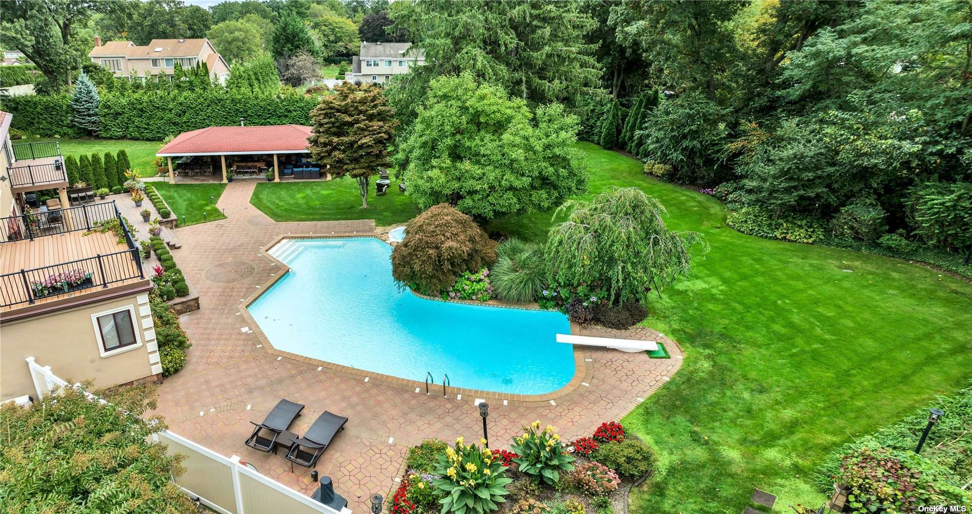 an aerial view of a house with a swimming pool yard and outdoor seating