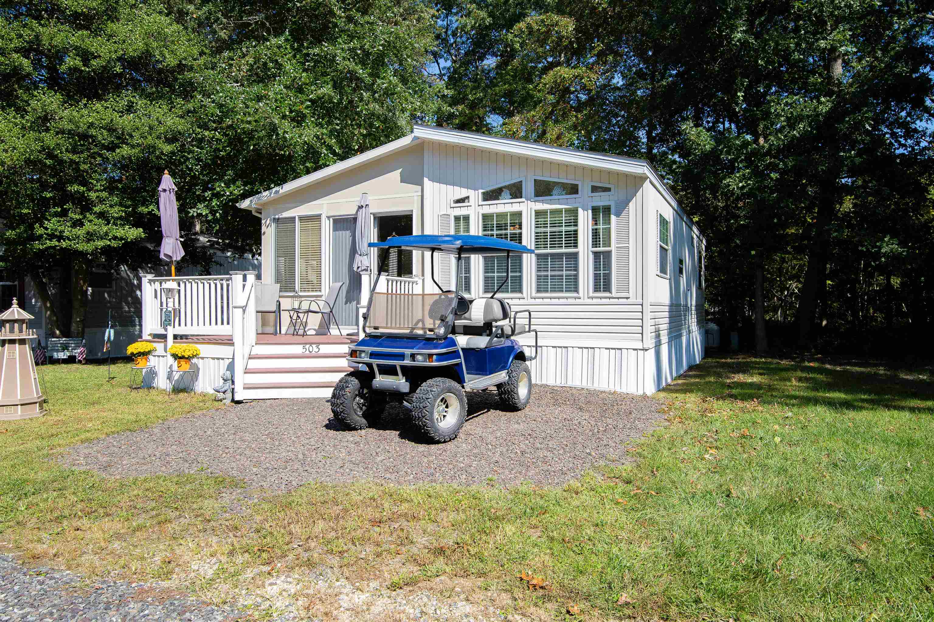 a view of a house with a patio and a yard